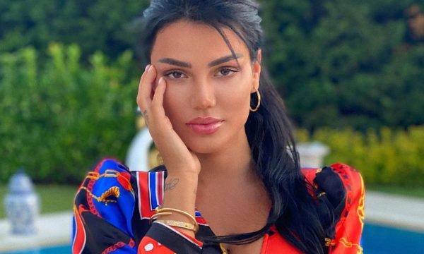 Morena me pozë tërheqëse, mbulon gjoksin me duar